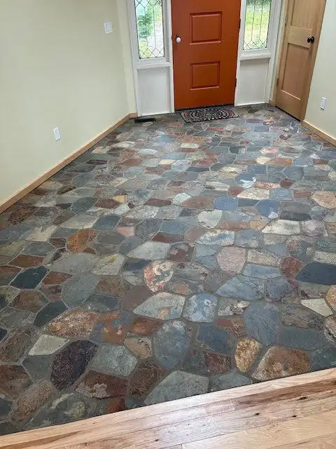 Foyer floor of irregular slate pieces in rust, blue and gray tones